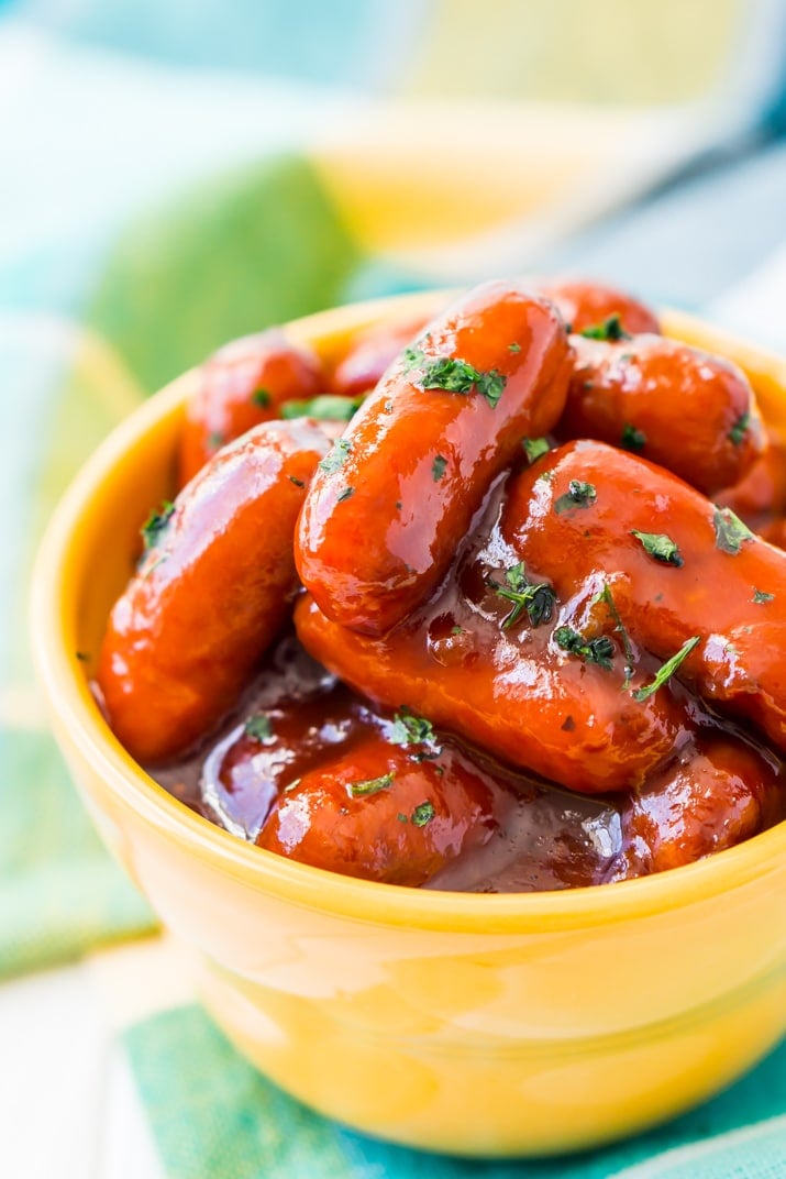 These Peach Barbecue Little Smokies are going to be an instant game day party hit! Made in the slow cooker with barbecue sauce, peach preserves, and cayenne pepper, it’s an addictive appetizer recipe everyone will love!