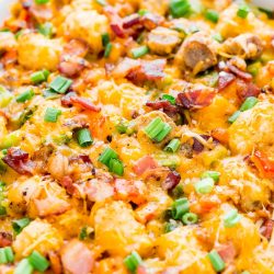 This Tater Tot Breakfast Casserole is an easy and delicious savory breakfast recipe the whole family will love! Everyone will love the mix of bacon, sausage, peppers, cheesy and more mixed into this tasty recipe!