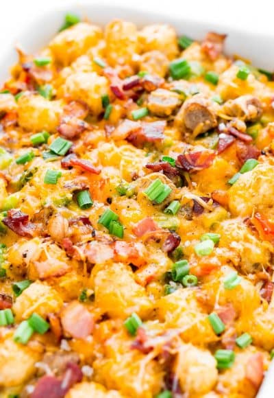 This Tater Tot Breakfast Casserole is an easy and delicious savory breakfast recipe the whole family will love! Everyone will love the mix of bacon, sausage, peppers, cheesy and more mixed into this tasty recipe!