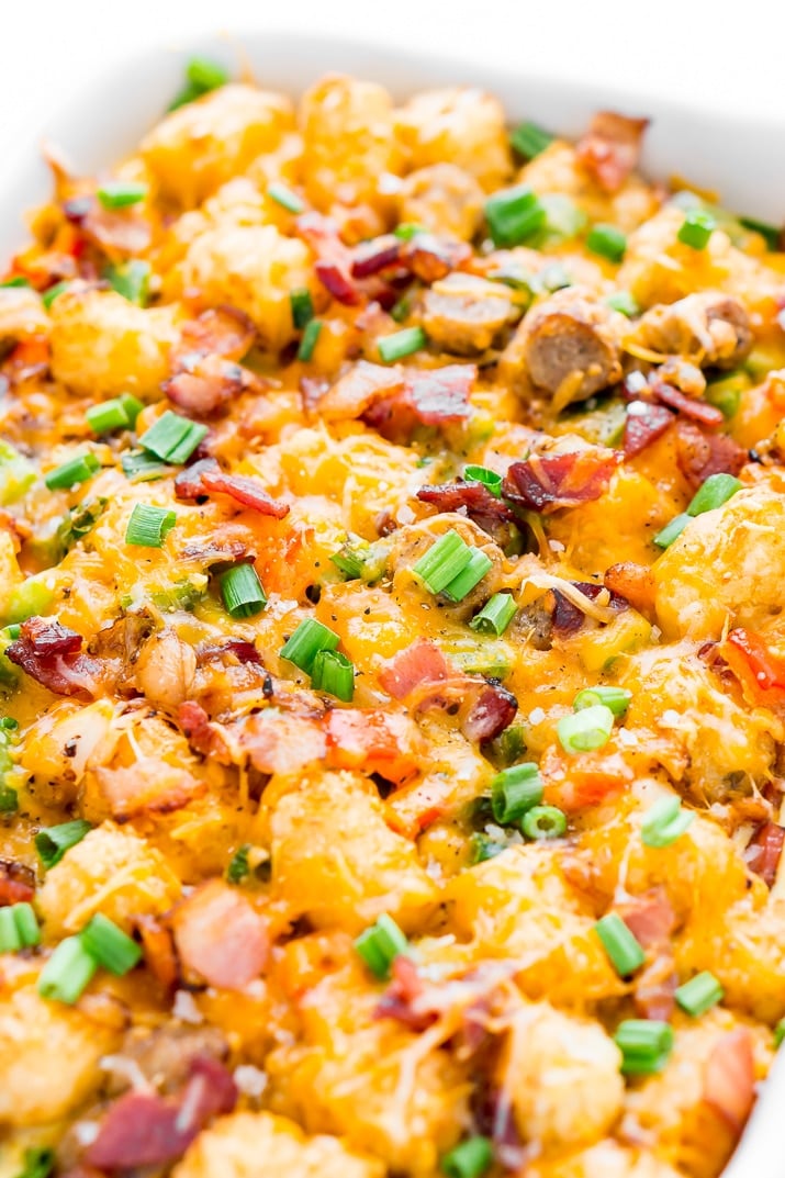 Tater Tot Breakfast Casserole loaded with bacon, sausage, peppers, cheese, scallions and more!