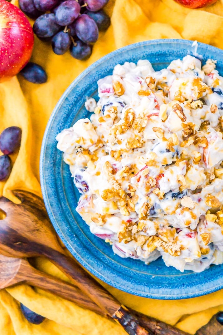 This Apple Grape Salad is a vintage dessert salad made with cream cheese, yogurt, apples, grapes, walnuts, and sugar! It's a potluck favorite and everyone will want the recipe!