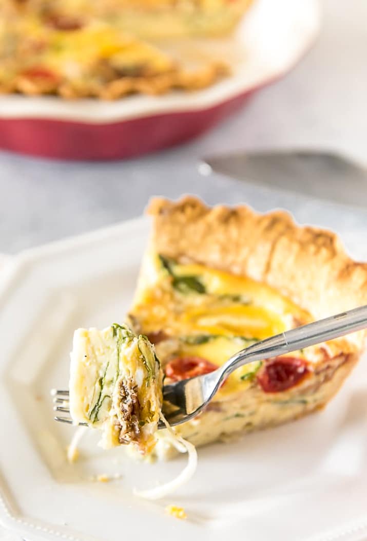 Fork with a bite of Bacon Onion Spinach Quiche Lorraine