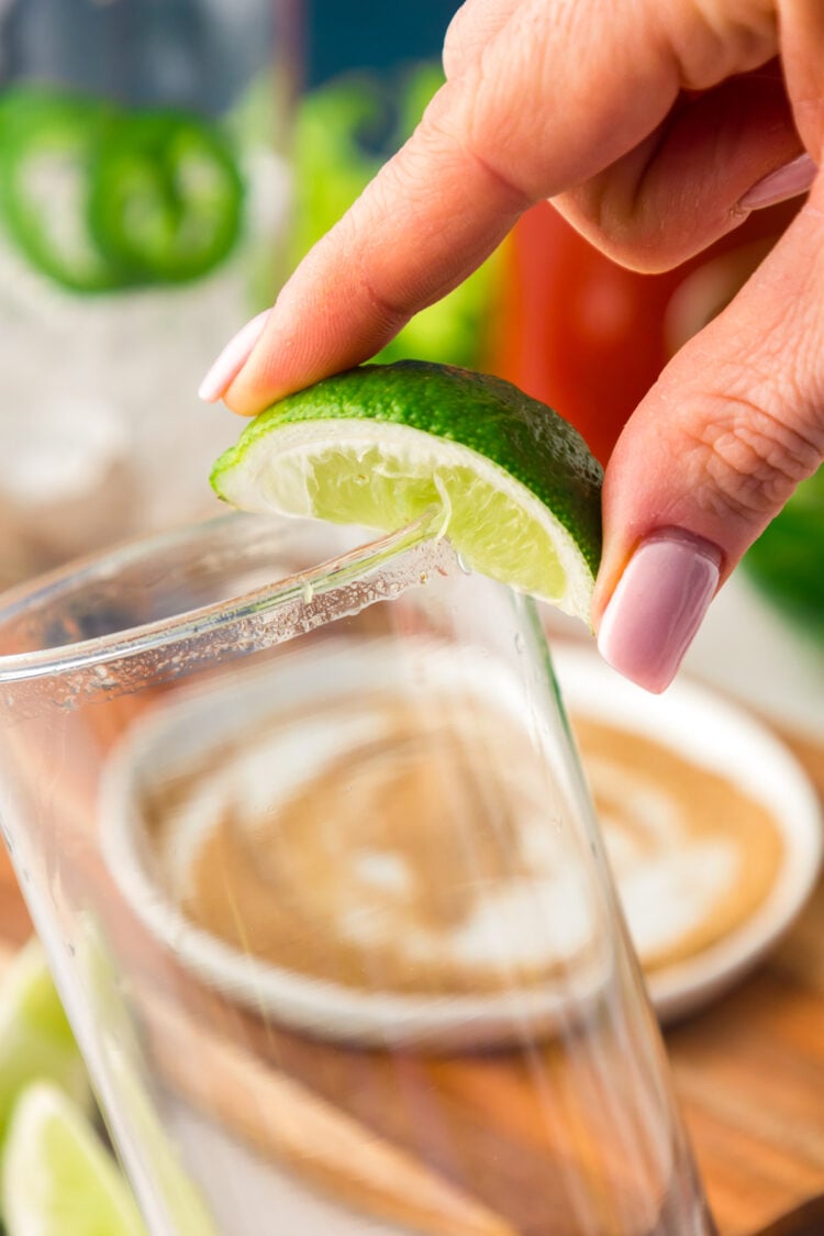 Lime being run around the rim of a glass.