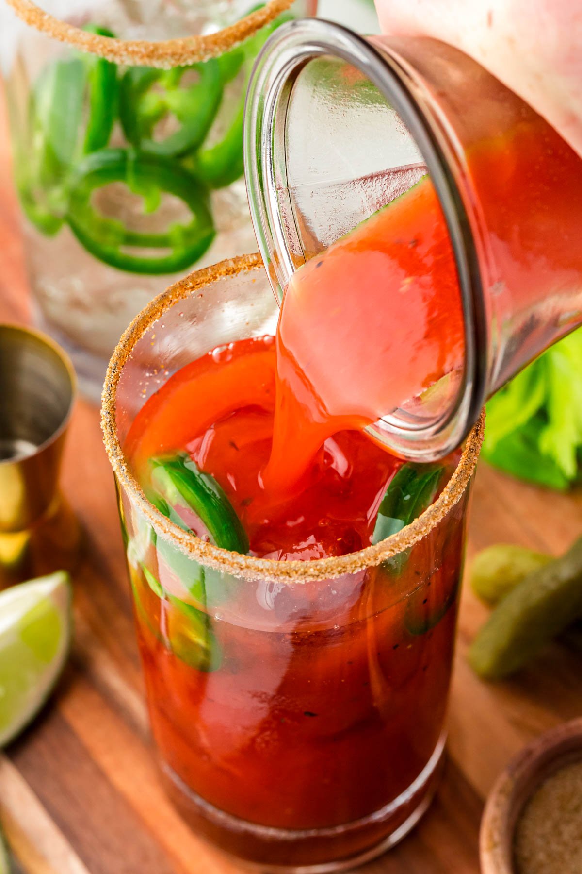 Bloody Mary mixer being poured into glasses.