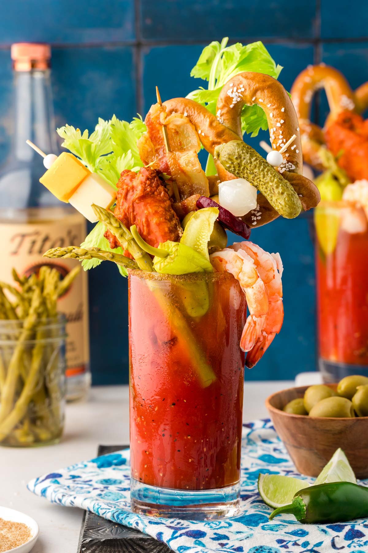 A glass filled with a Bloody Mary topped with extravagant garnishes for brunch.