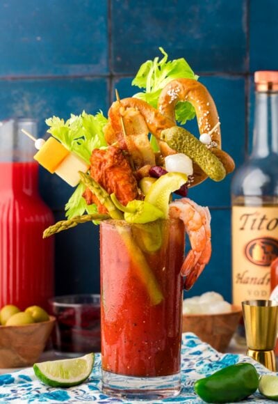 A glass filled with a Bloody Mary topped with extravagant garnishes for brunch.