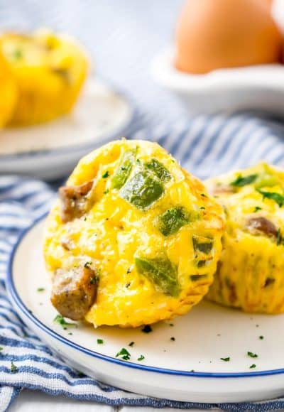 Close up photo of two mini quiche on a plate.