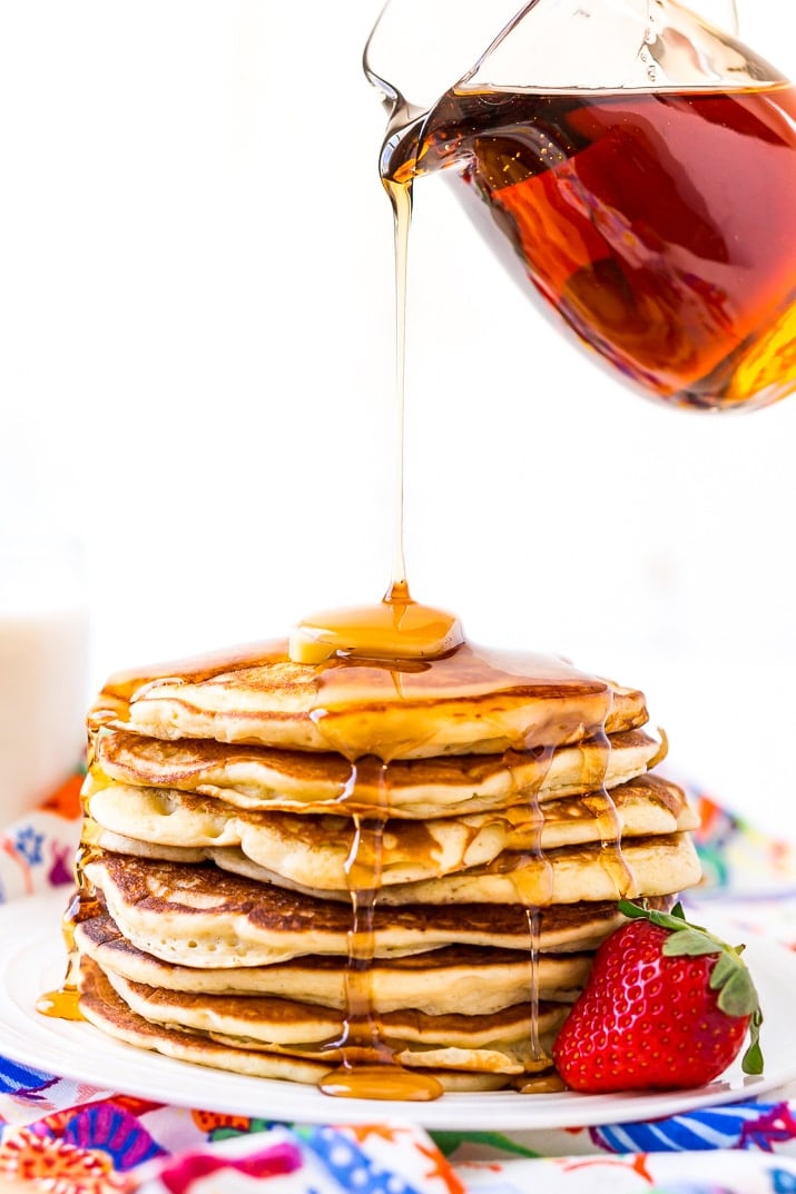 Pouring Maple Syrup on a stack of Homemade Buttermilk Pancakes