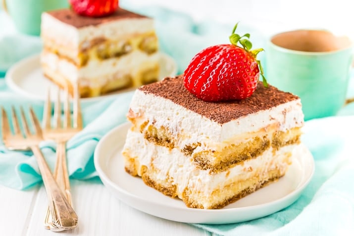 Homemade Tiramisu on White Plate with Strawberry On Top