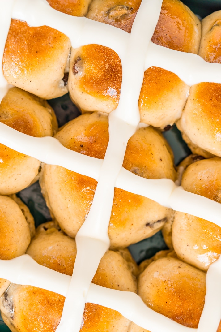 Overhead shot of hot cross buns in pan with icing