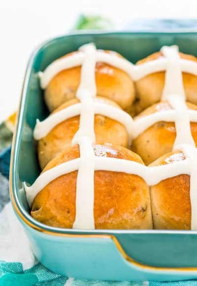 These Hot Cross Buns are a spiced sweet bun loaded with currants or raisins and topped with vanilla icing. They're a traditional Good Friday and Easter recipe!