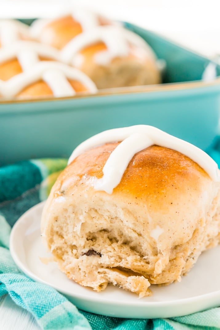 Hot cross bun on plate with blue napkin