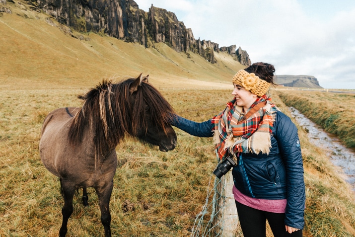 Woman petting Icelandic horse