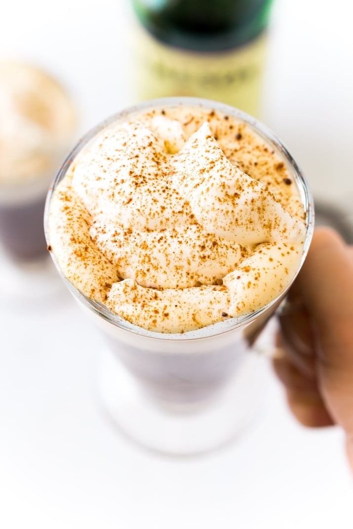 Irish Coffee made with coffee, whiskey, sugar, and whipped cream.