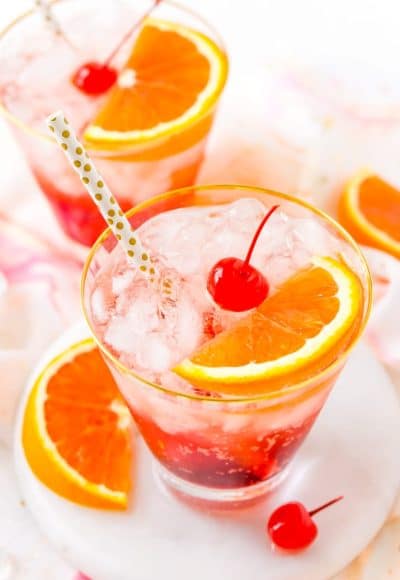 This Shirley Temple drink is a classic and nostalgic mocktail recipe made with homemade grenadine, ginger ale, ice, and an orange slice!