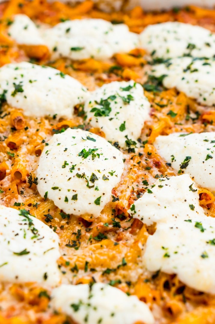 Close up of Ricotta pasta bake showing garnishes and penne.