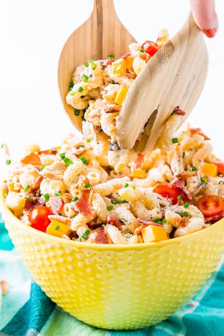 This Chicken Bacon Ranch Pasta Salad is going to be an instant hit at BBQs and picnics this summer! It's loaded with chicken, bacon, cheese, olives, and coated with a delicious ranch dressing.