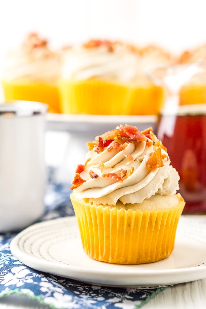 Maple Bacon Cupcakes on plate with cup of coffee and maple syrup