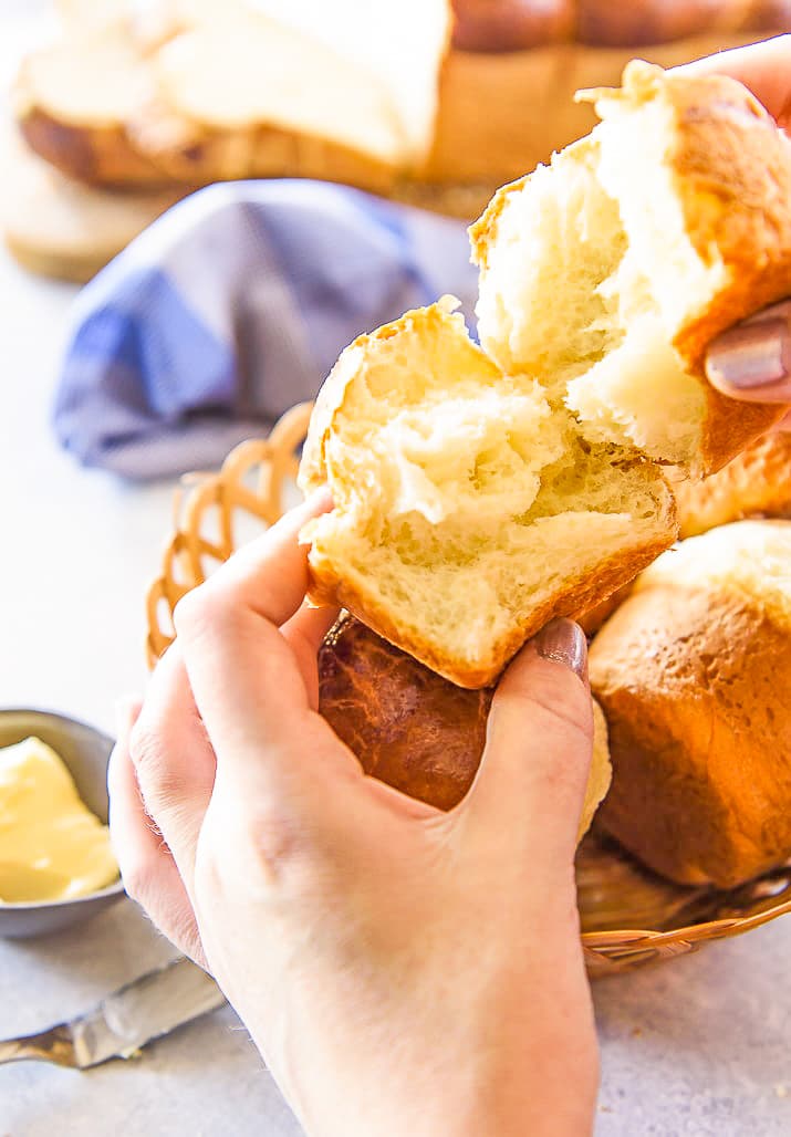 woman pulling apart a brioche roll