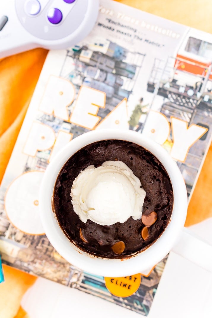 Microwave Brownie Mug Cake in white mug with Ready Player One book