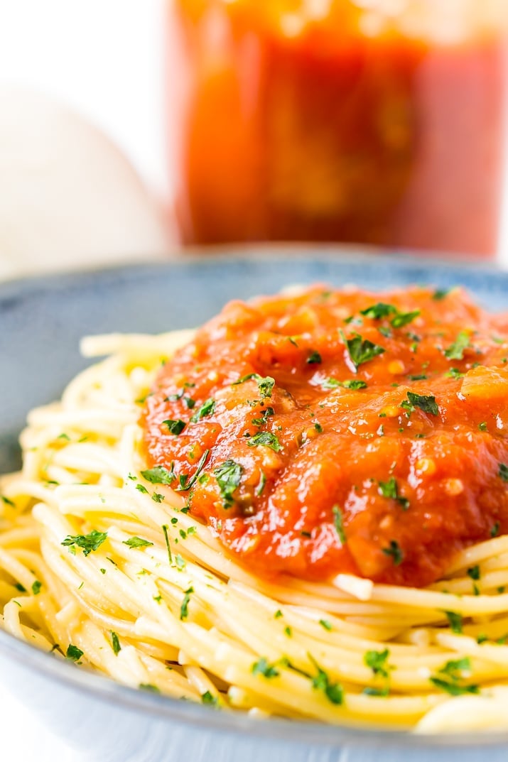 Homemade Pomodoro Sauce on spaghetti in blue bowl