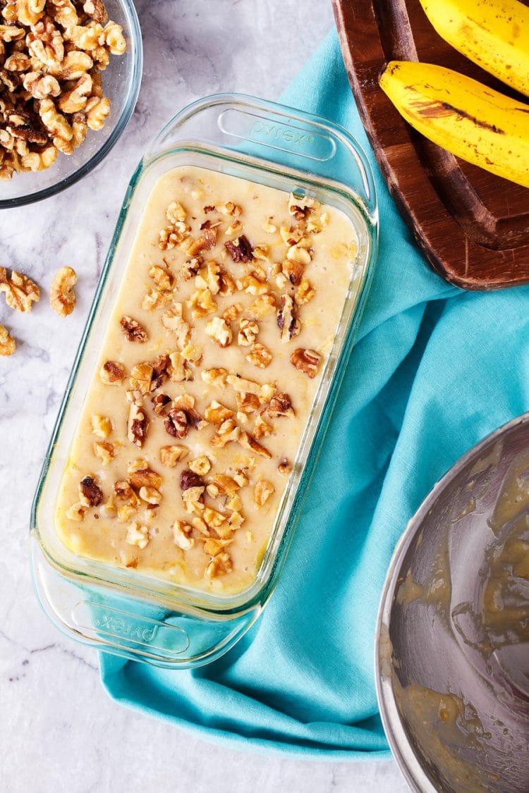 Banana bread batter in loaf pan ready to be baked. 