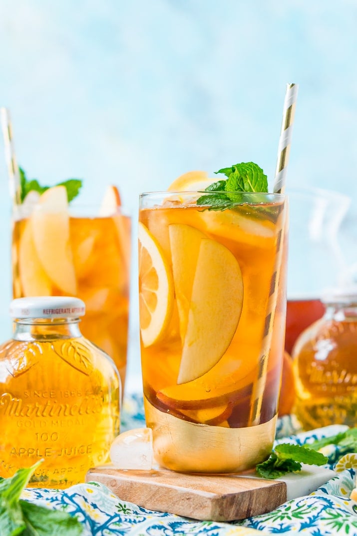 This Homemade Apple Iced Tea is made with freshly brewed black tea, sweet apple juice, fresh apple slices, and a squeeze of lemon for a refreshing summer drink that's easy to make. This flavored iced tea is naturally sweetened by the fruit juice and great for a party!