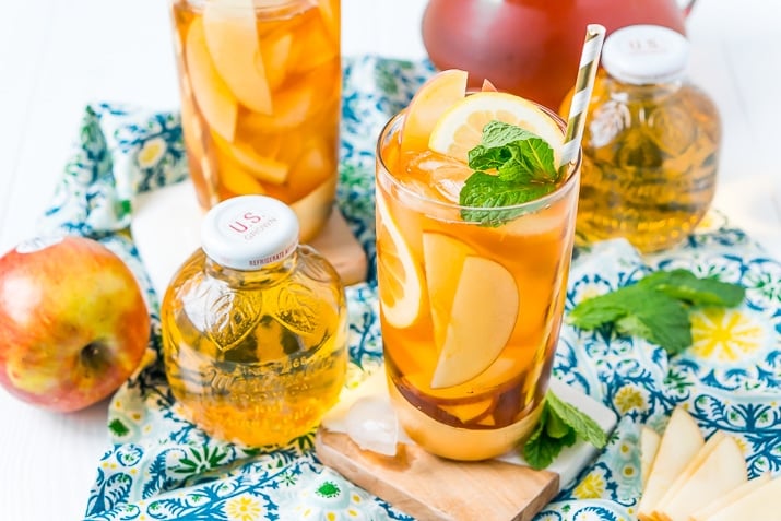 This Homemade Apple Iced Tea is made with freshly brewed black tea, sweet apple juice, fresh apple slices, and a squeeze of lemon for a refreshing summer drink that's easy to make. This flavored iced tea is naturally sweetened by the fruit juice and great for a party!