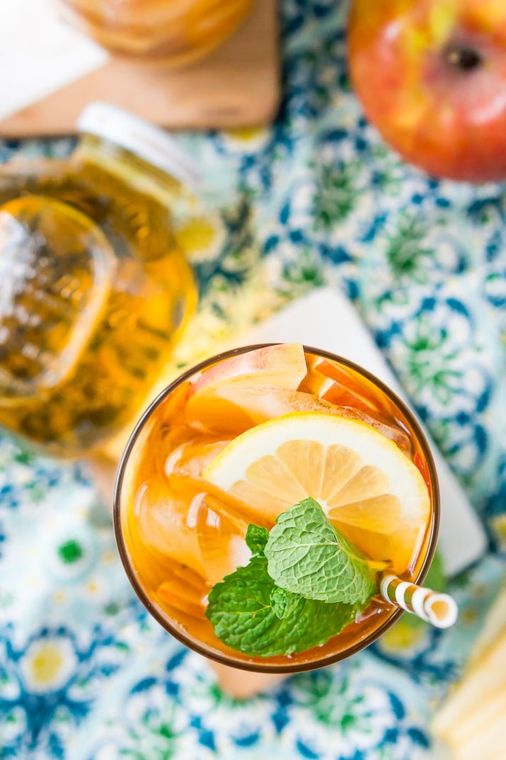 This Homemade Apple Iced Tea is made with freshly brewed black tea, sweet apple juice, fresh apple slices, and a squeeze of lemon for a refreshing summer drink that's easy to make. This flavored iced tea is naturally sweetened by the fruit juice and great for a party!