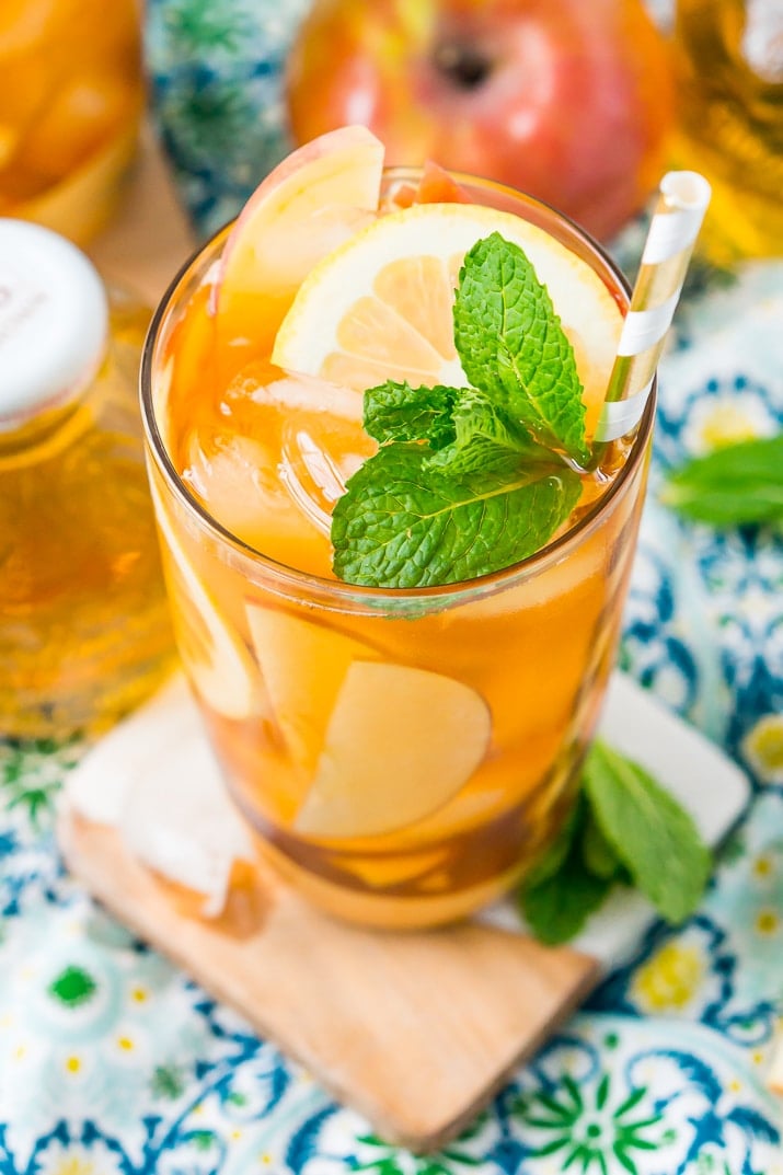 This Homemade Apple Iced Tea is made with freshly brewed black tea, sweet apple juice, fresh apple slices, and a squeeze of lemon for a refreshing summer drink that's easy to make. This flavored iced tea is naturally sweetened by the fruit juice and great for a party!