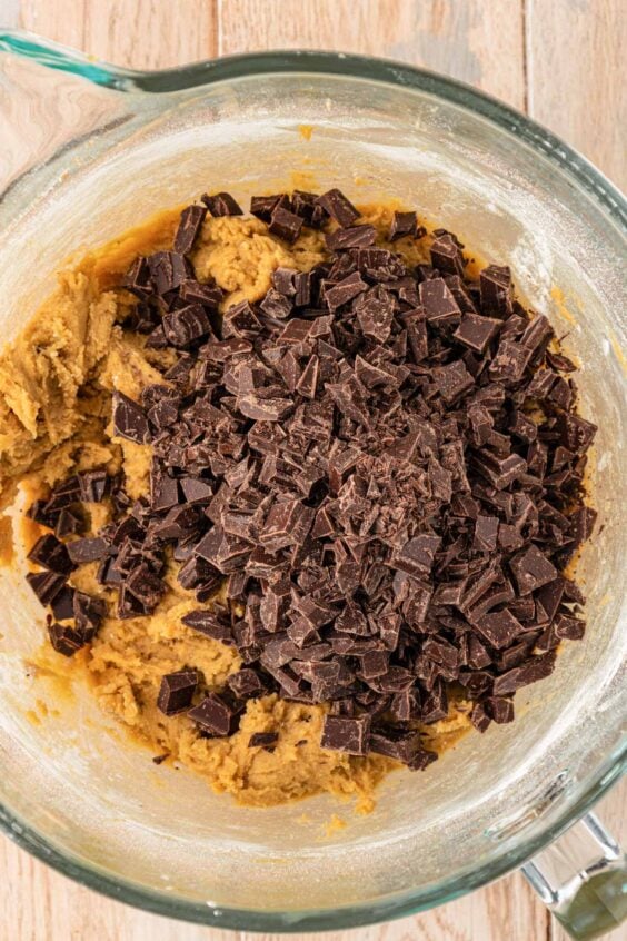 Chopped Chocolate being added to cookie dough.