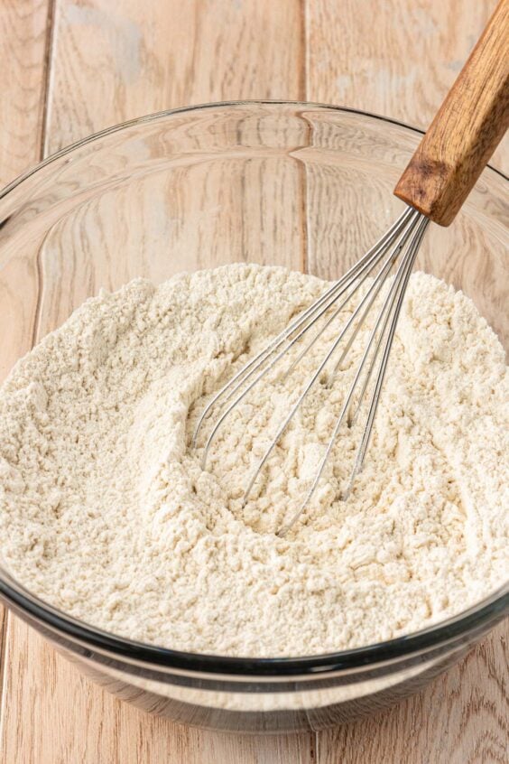 Dry ingredients being whisked together in a a mixing bowl.