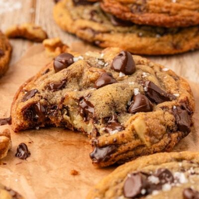 Close up of a toll house cookie with a bite missing.