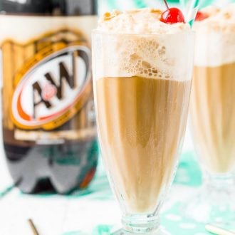 two root beer float in glasses with two liter bottle of root beer in the background