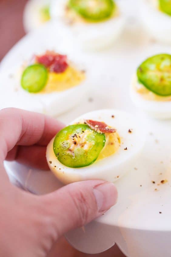 Woman grabbing deviled egg.