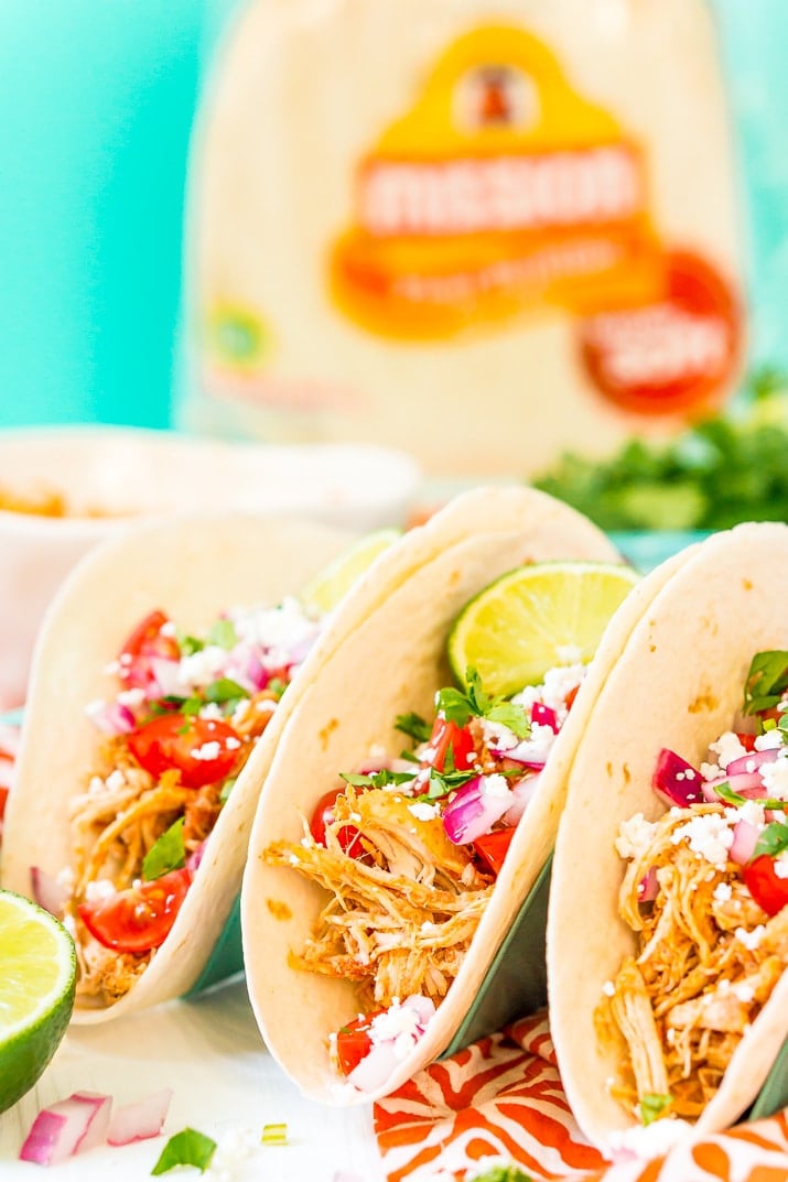 These Shredded Chicken Tacos are an easy and flavorful dinner to enjoy with friends and family. The chicken is loaded with spices and topped with fresh veggies and cheese all wrapped in a super soft flour tortilla.