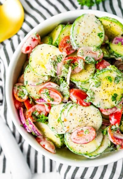 This Cucumber Tomato Salad is a simple and refreshing side dish that can be made with a creamy Italian dressing or a vinegar dressing.