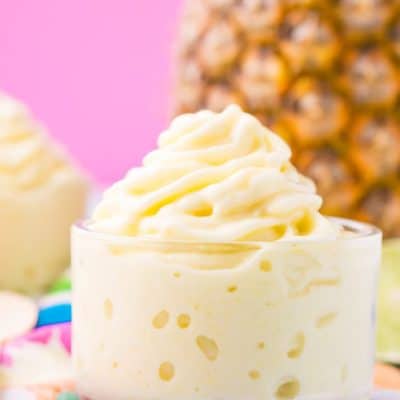 This Dole Whip recipe is a copycat of the famous Disney soft serve pineapple, banana, and coconut treat we all know and love! But you can make it right at home with just 4 ingredients and a blender!