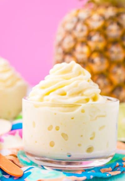 This Dole Whip recipe is a copycat of the famous Disney soft serve pineapple, banana, and coconut treat we all know and love! But you can make it right at home with just 4 ingredients and a blender!