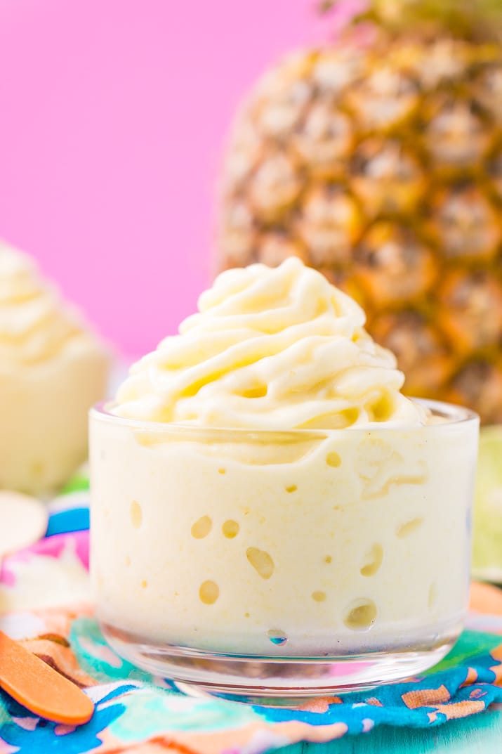 This Dole Whip recipe is a copycat of the famous Disney soft serve pineapple, banana, and coconut treat we all know and love! But you can make it right at home with just 4 ingredients and a blender!