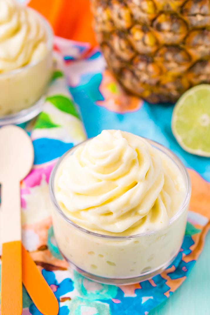 This Dole Whip recipe is a copycat of the famous Disney soft serve pineapple, banana, and coconut treat we all know and love! But you can make it right at home with just 4 ingredients and a blender!