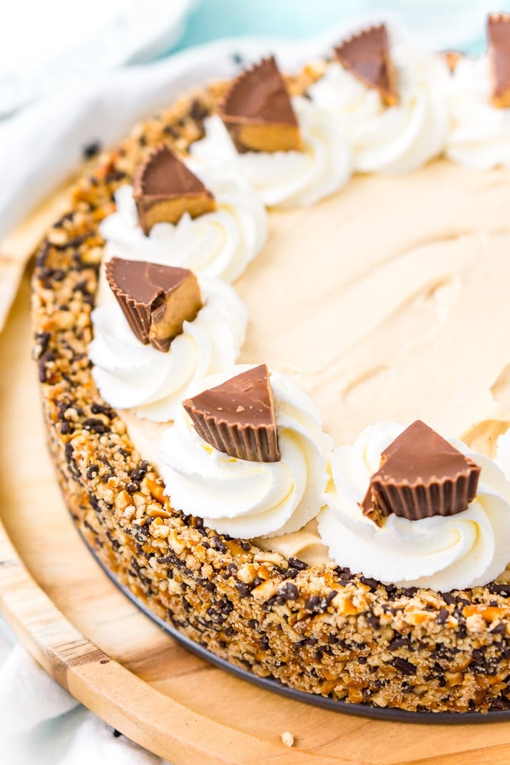 This No Bake Peanut Butter Pie is an easy and sinful dessert recipe made with a pretzel crust, a creamy peanut butter filling, and topped with peanut butter cups.