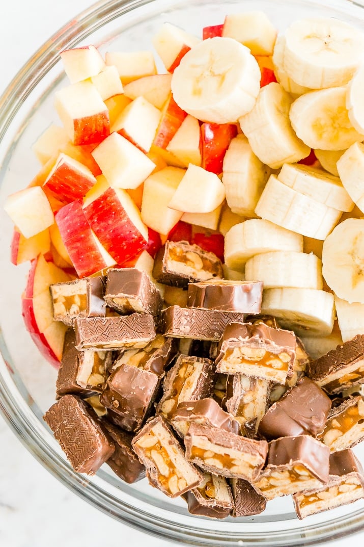 This Snickers Salad is an easy and addictive 4-ingredient no-bake dessert salad made with Snickers, banana, apples, and Cool Whip!