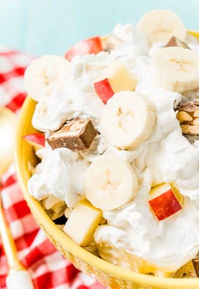 This Snickers Salad is an easy and addictive 4-ingredient no-bake dessert salad made with Snickers, banana, apples, and Cool Whip!