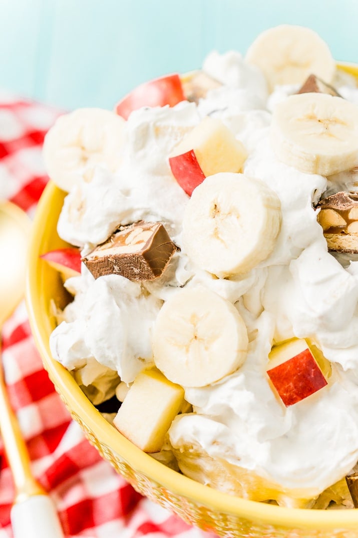 This Snickers Salad is an easy and addictive 4-ingredient no-bake dessert salad made with Snickers, banana, apples, and Cool Whip!