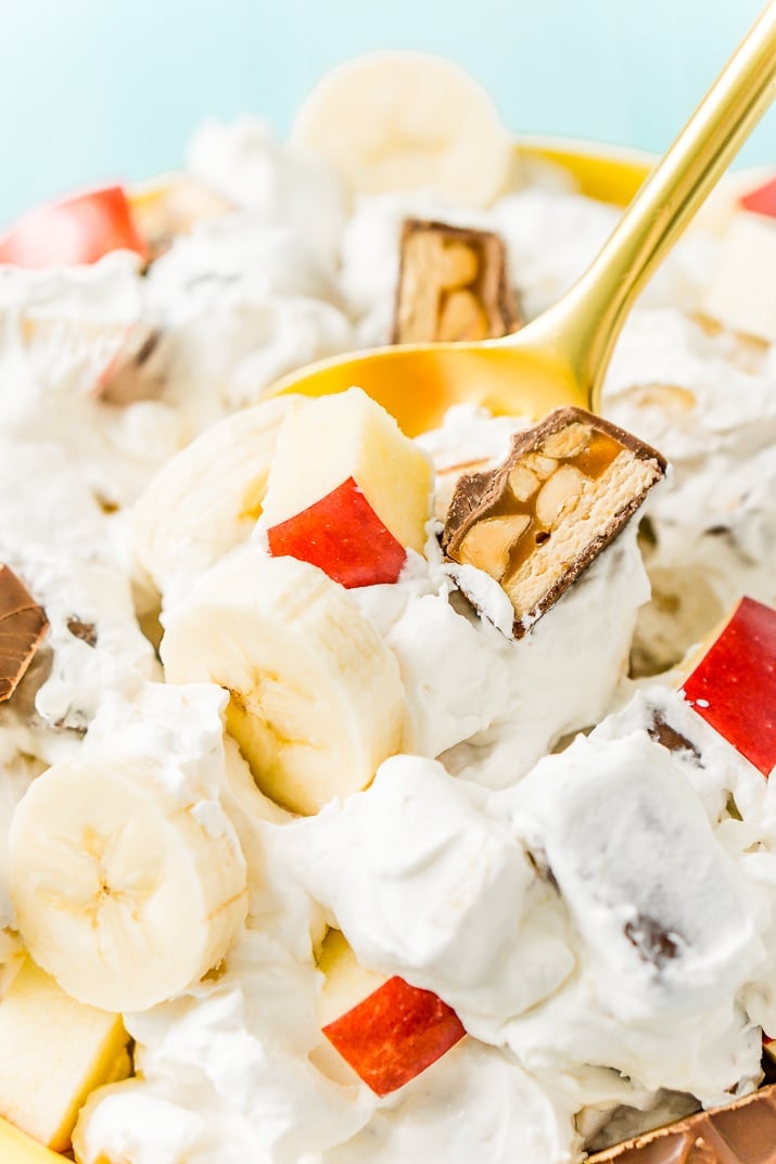 This Snickers Salad is an easy and addictive 4-ingredient no-bake dessert salad made with Snickers, banana, apples, and Cool Whip!