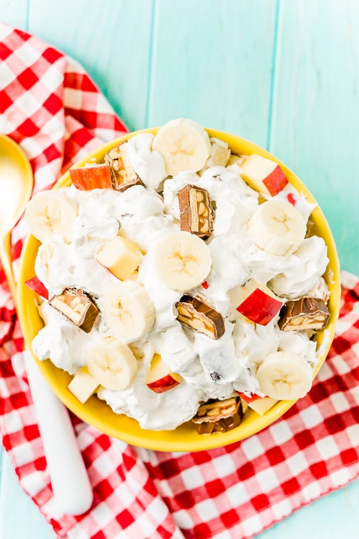 This Snickers Salad is an easy and addictive 4-ingredient no-bake dessert salad made with Snickers, banana, apples, and Cool Whip!