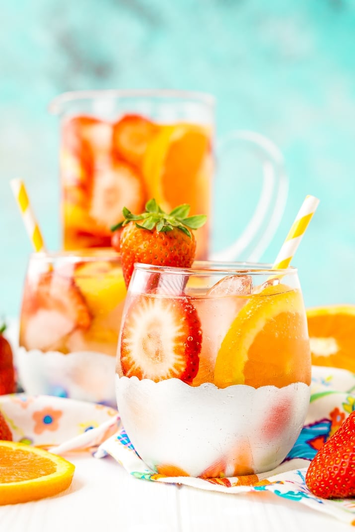 This White Wine Sangria recipe is made with juicy strawberries, oranges, and peaches as well as sweet simple syrup, apricot brandy, and a splash of club soda or seltzer! It's an easy and refreshing summer wine cocktail.