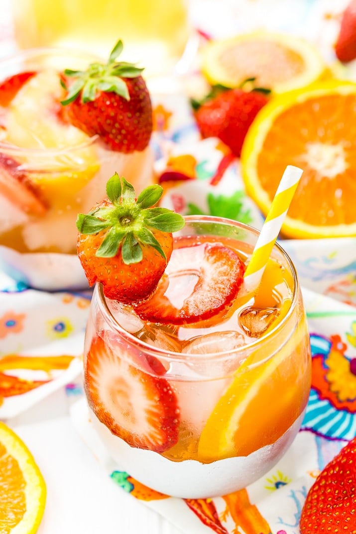 This White Wine Sangria recipe is made with juicy strawberries, oranges, and peaches as well as sweet simple syrup, apricot brandy, and a splash of club soda or seltzer! It's an easy and refreshing summer wine cocktail.