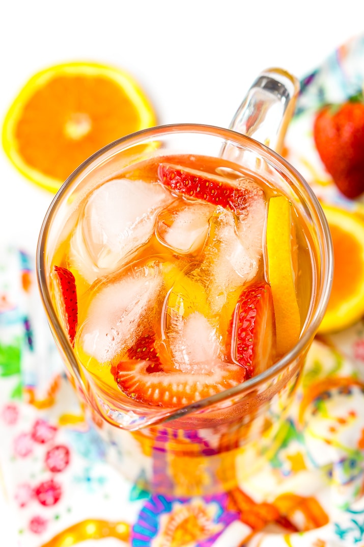 This White Wine Sangria recipe is made with juicy strawberries, oranges, and peaches as well as sweet simple syrup, apricot brandy, and a splash of club soda or seltzer! It's an easy and refreshing summer wine cocktail.